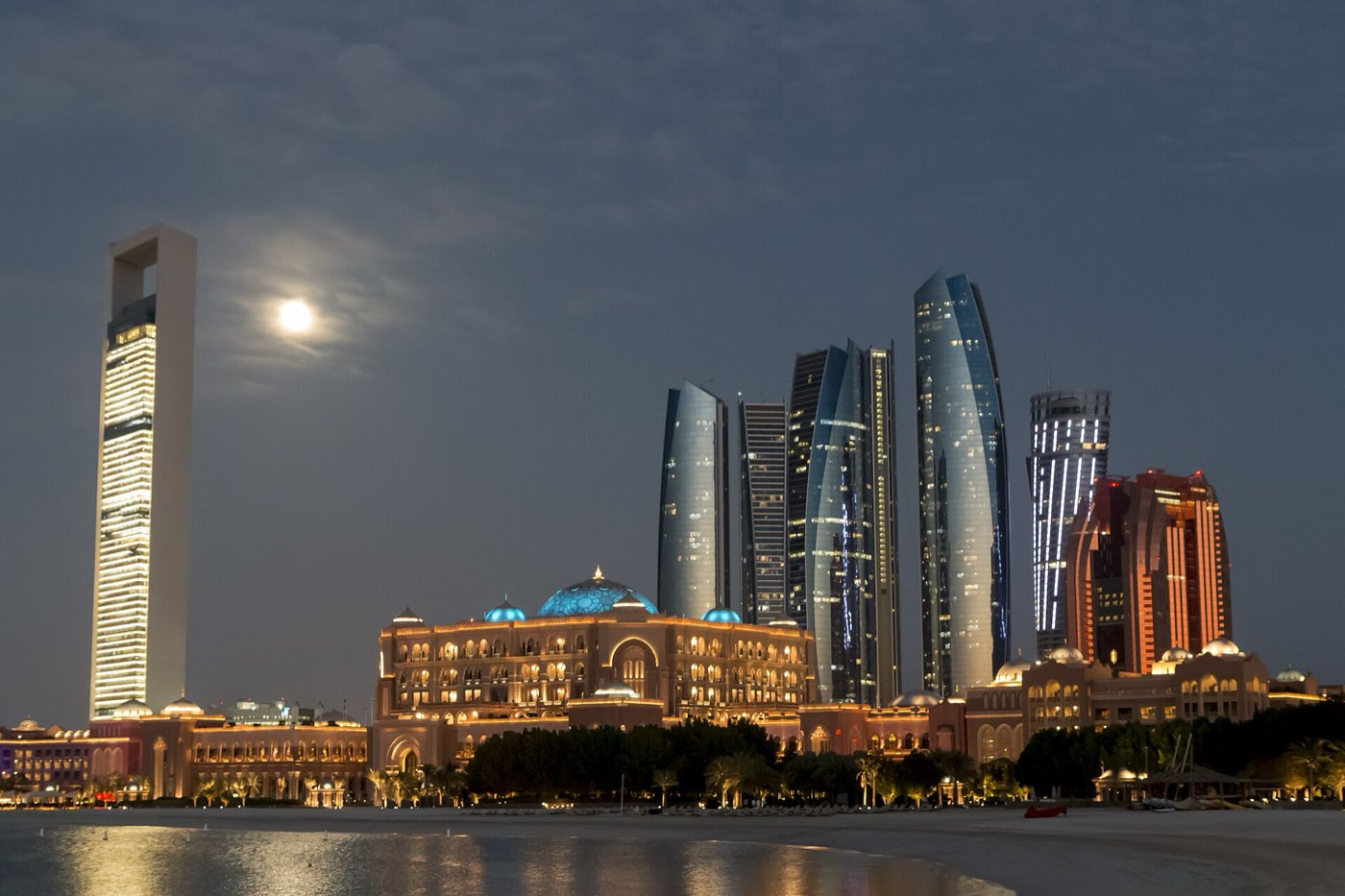 The Abu Dhabi skyline at night, seen across the water from the Corniche.