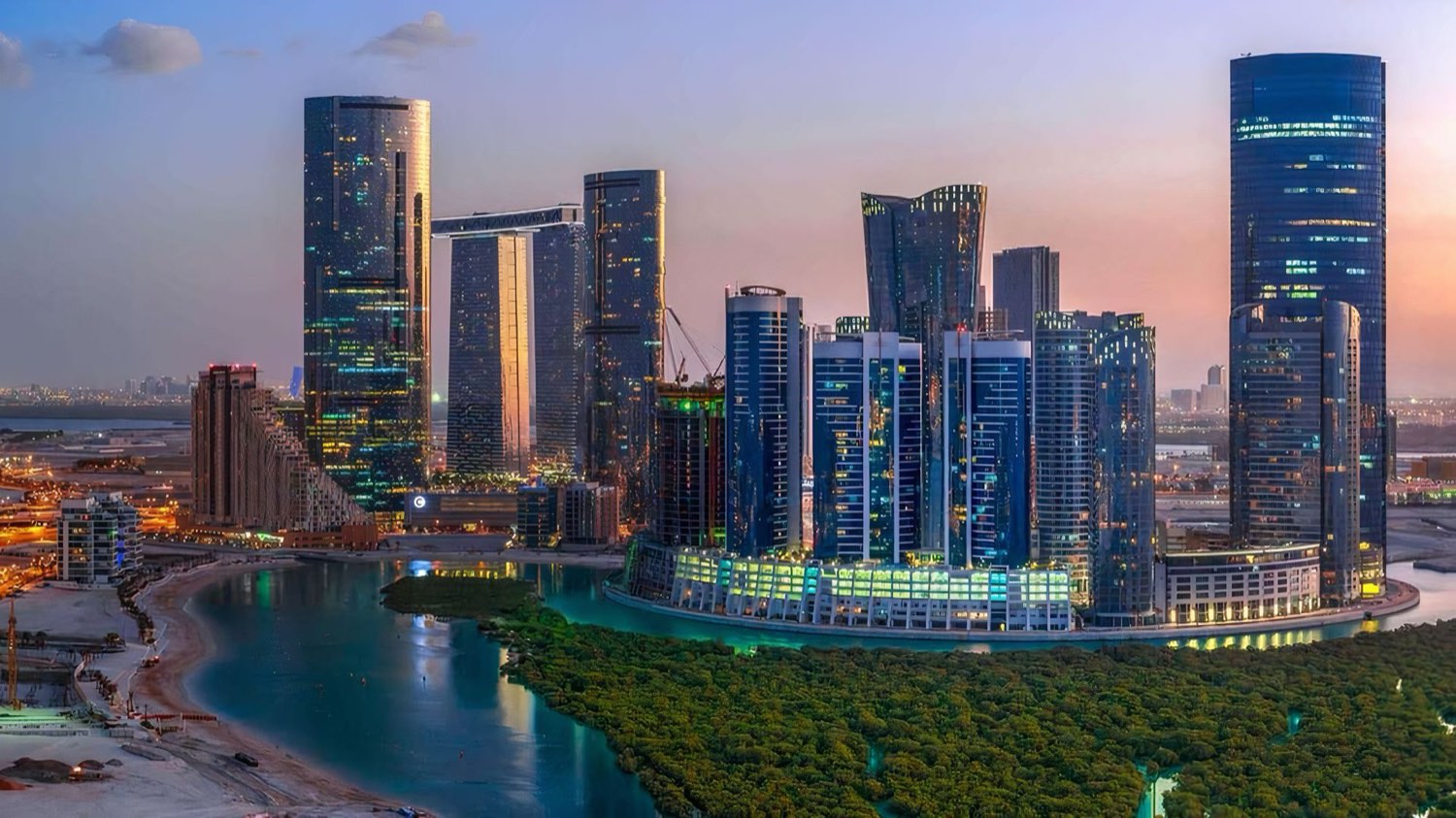 The residential towers of Shams Abu Dhabi on Al Reem Island reflected in calm water.